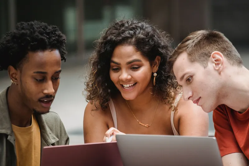 Students studying together on a laptop